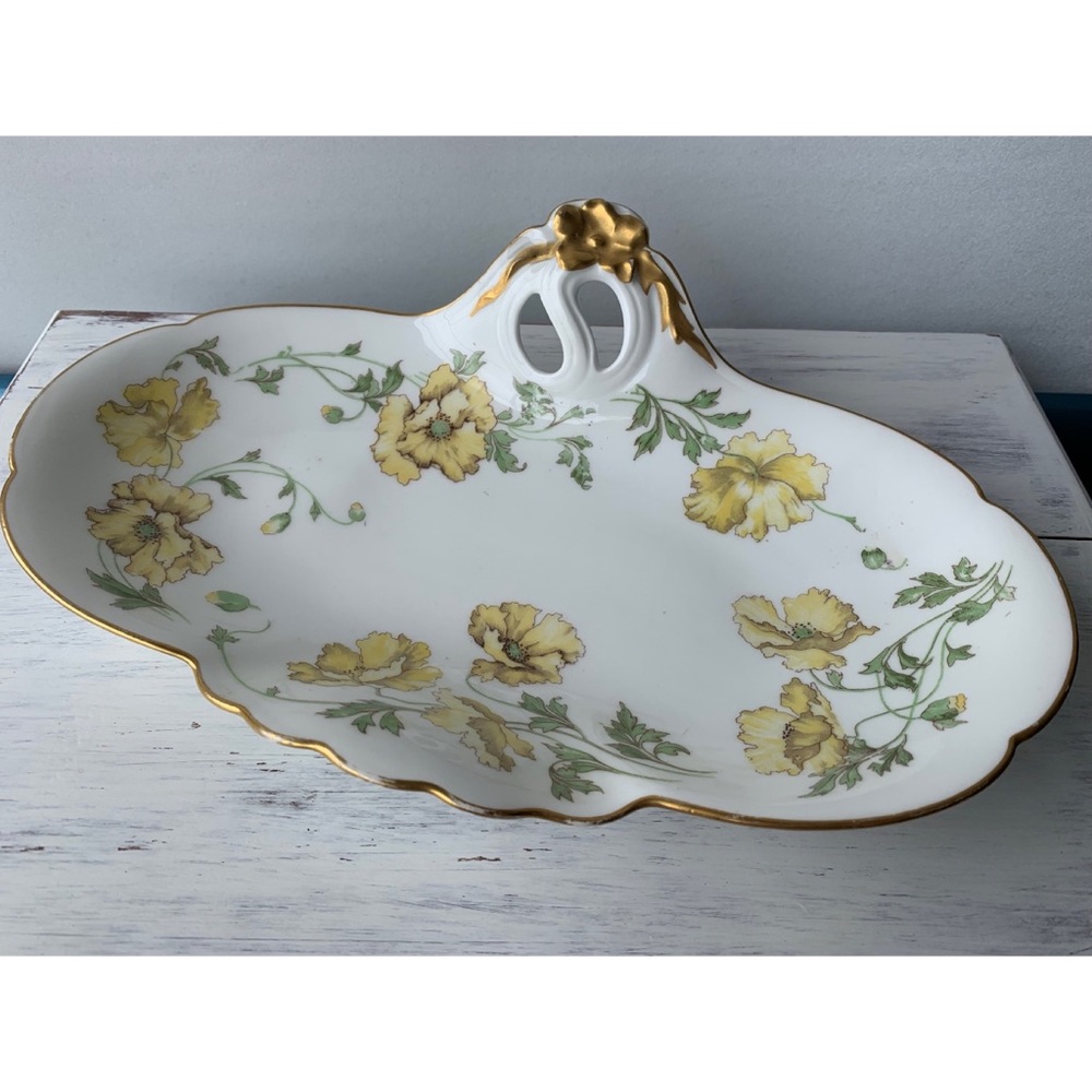 Vintage white porcelain serving dish with gold and floral border.